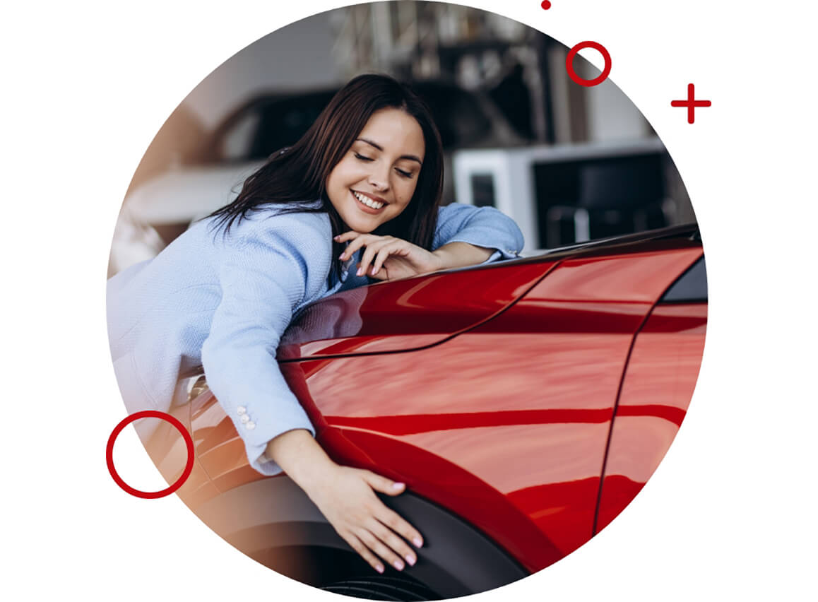 Smiling woman hugging a red car.